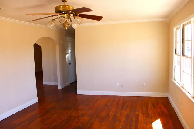 a view of a room with wooden floor and a window