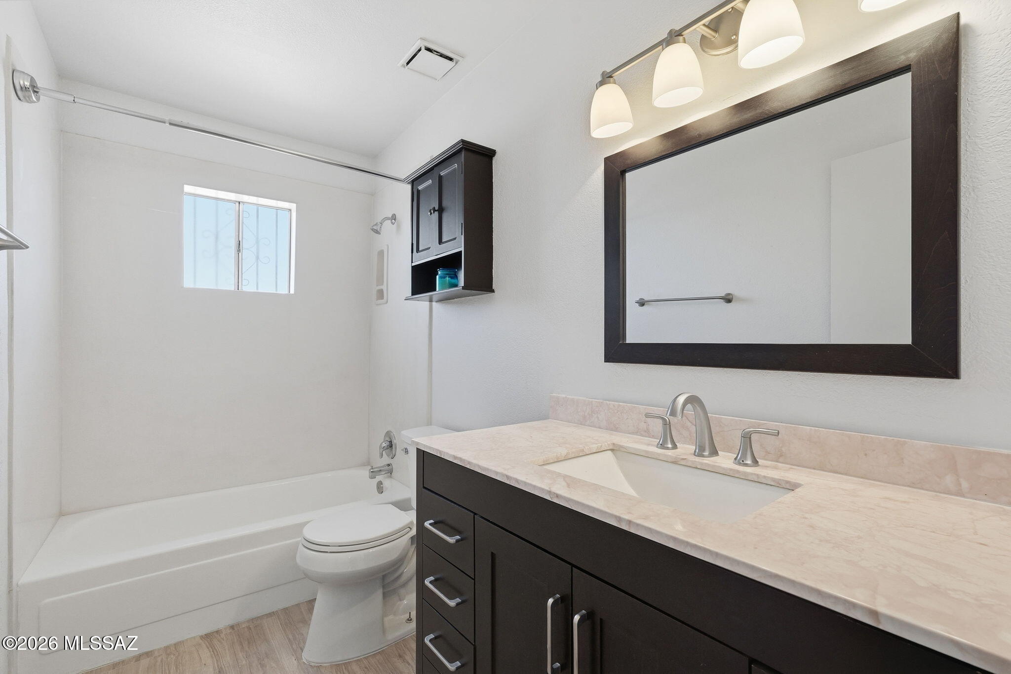 136 West Elvira Road Tucson, AZ 85756 - Photo 21 of 27 a bathroom with a toilet a sink a bathtub and a mirror