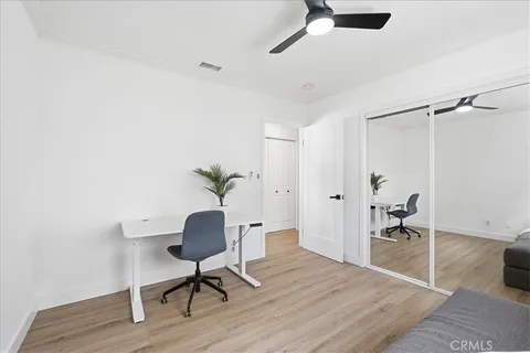 a workspace room with furniture and wooden floor