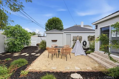 a view of a patio with table and chairs under an umbrella