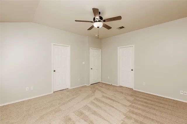 a view of a room with a ceiling fan