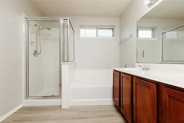 a bathroom with a shower sink and mirror
