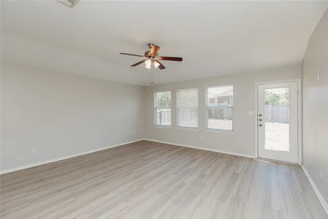 wooden floor in an empty room with a window