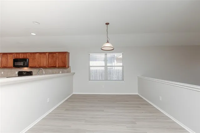 a view of a kitchen with a sink cabinets and wooden floor