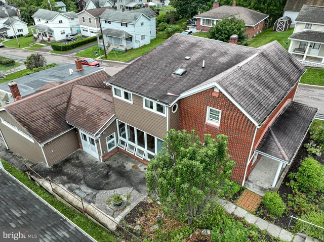 an aerial view of multiple houses with a yard