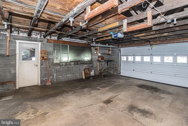 a bathroom with a sink mirror and shower