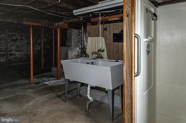 a view of a house with a yard and potted plants