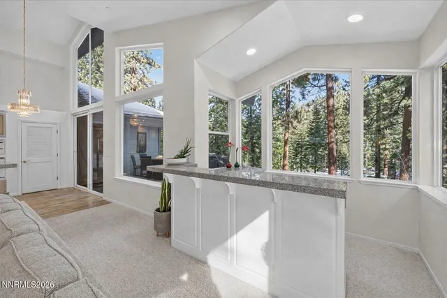 a kitchen with stainless steel appliances granite countertop a sink a stove and a refrigerator