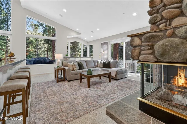 a living room with furniture and a floor to ceiling window