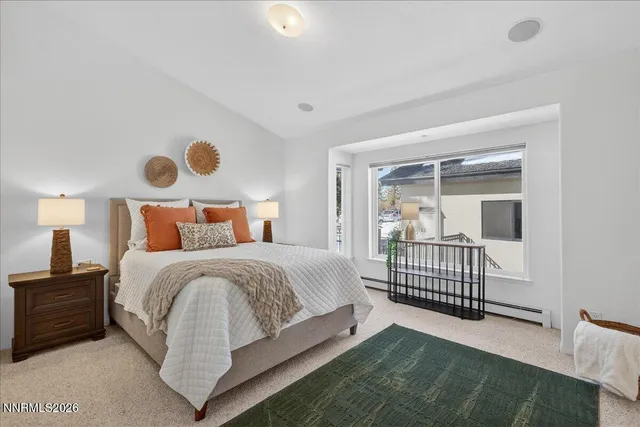 a bathroom with a granite countertop sink a toilet a mirror and shower