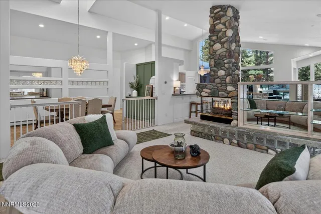 a living room with furniture and a chandelier