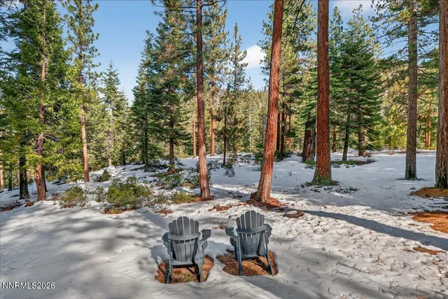 a large kitchen with granite countertop a sink and cabinets with wooden floor