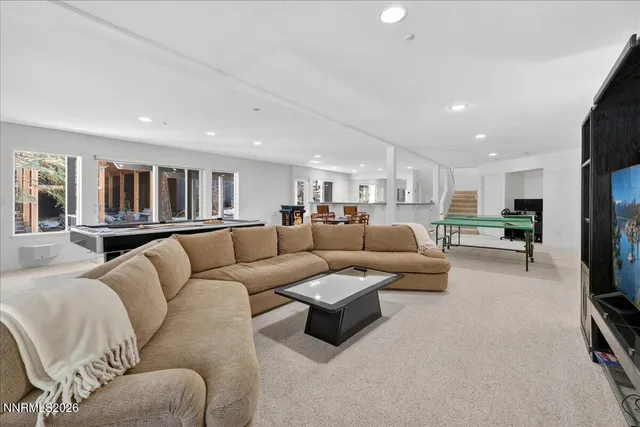 a view of a road with plants and large trees