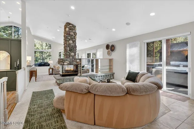 a front view of a house with a tree