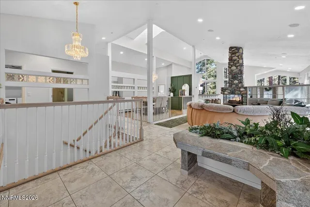 a dining room with furniture a chandelier and wooden floor