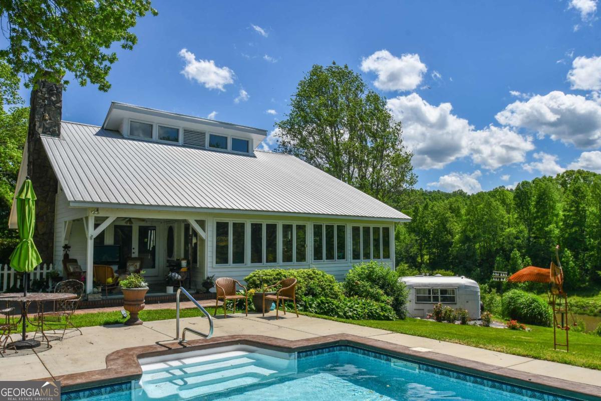 708 Hub Tatum Road Sautee Nacoochee, GA 30571 - Photo 18 of 100 a front view of a house with garden and porch