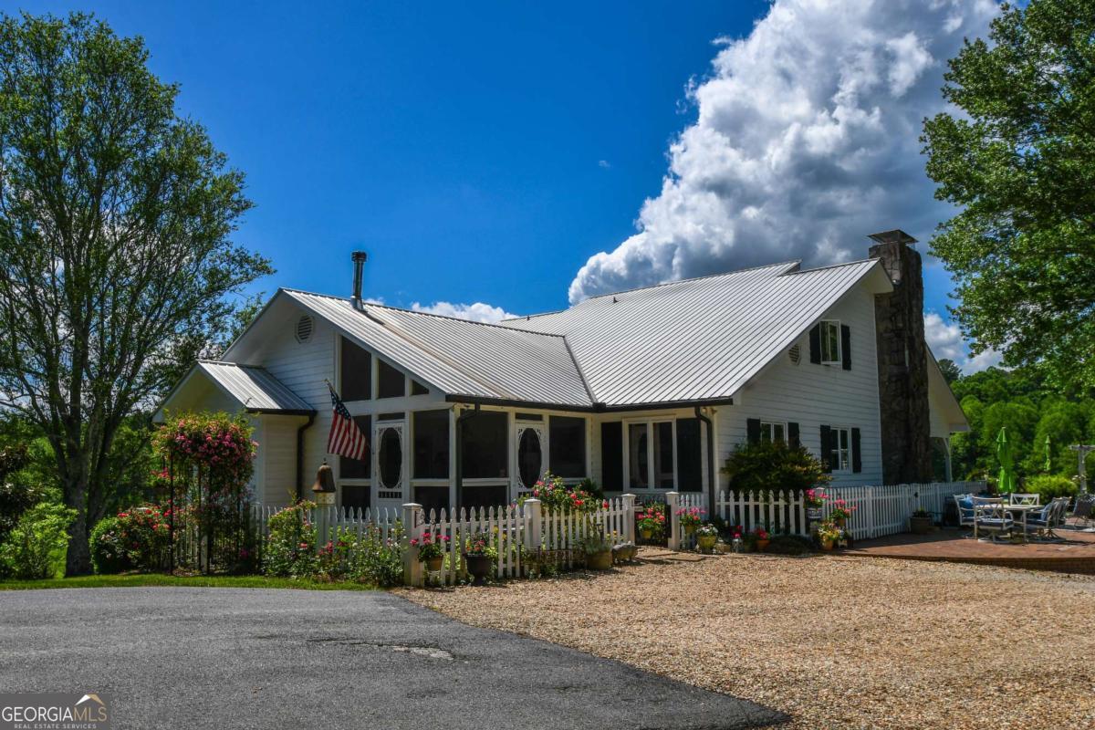 708 Hub Tatum Road Sautee Nacoochee, GA 30571 - Photo 29 of 100 a view of a house that has a bunch of plants and large trees