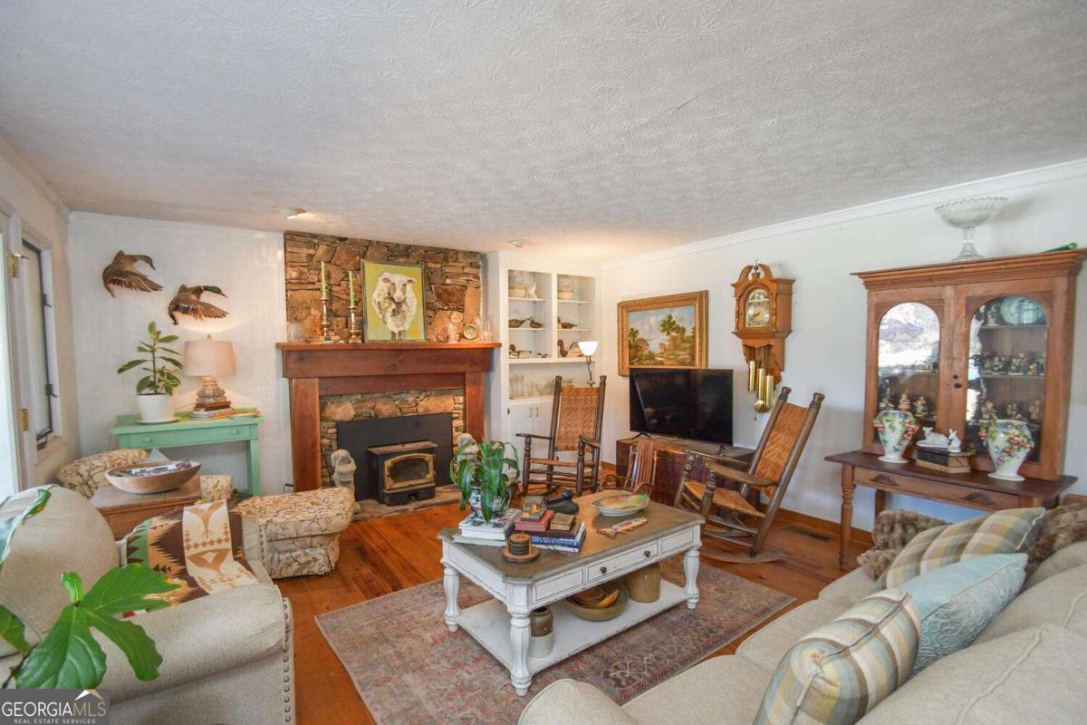 708 Hub Tatum Road Sautee Nacoochee, GA 30571 - Photo 44 of 100 a living room with furniture fireplace and a large window