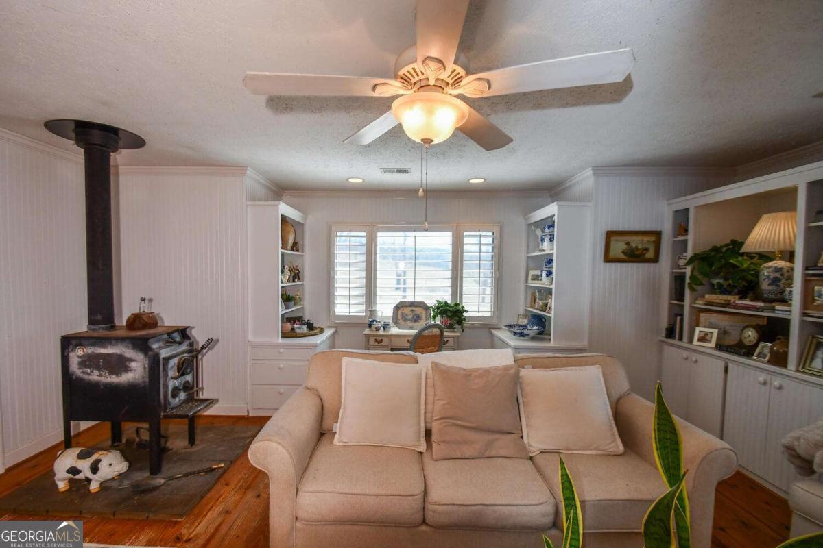 708 Hub Tatum Road Sautee Nacoochee, GA 30571 - Photo 47 of 100 a living room with furniture a chandelier and a flat screen tv