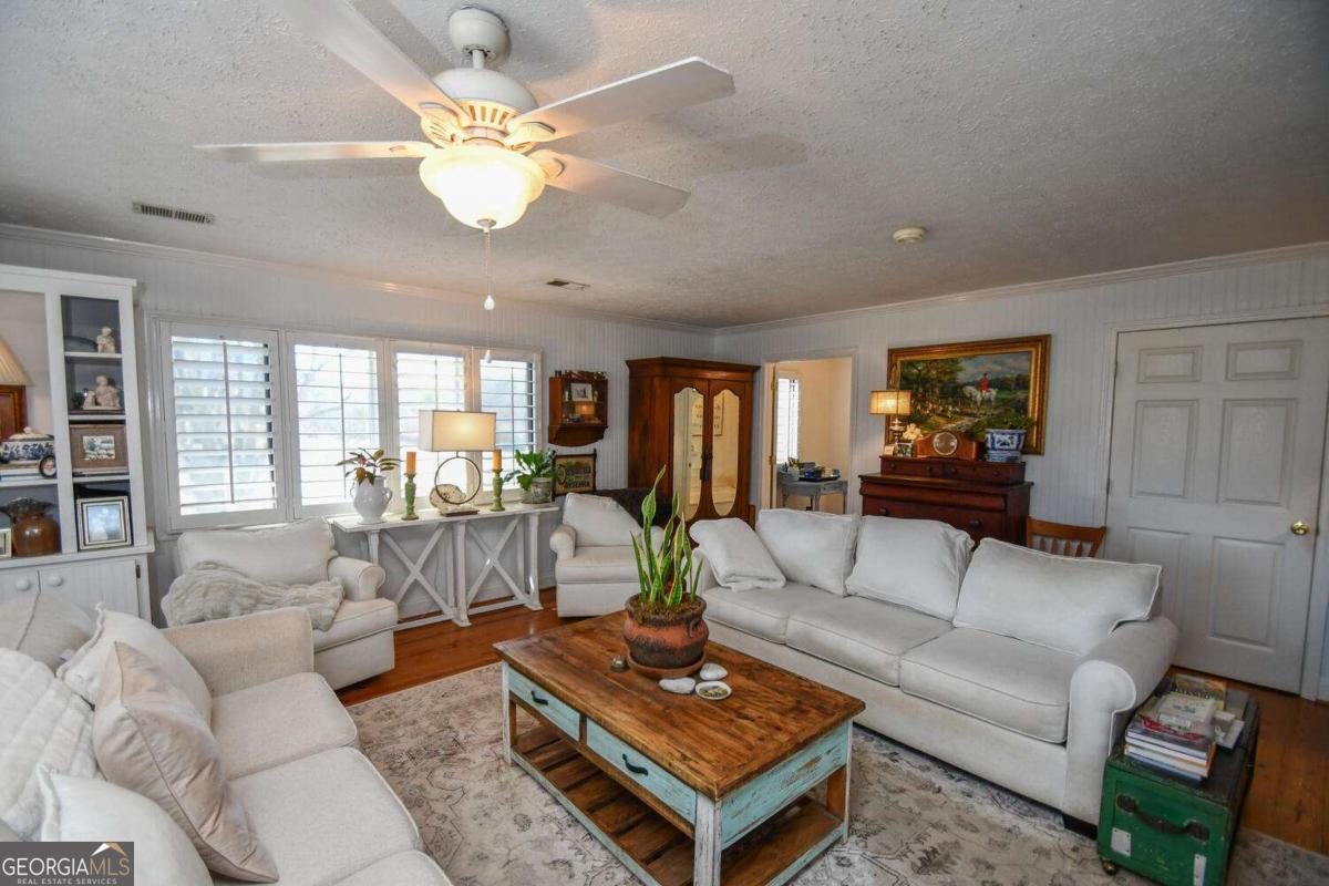708 Hub Tatum Road Sautee Nacoochee, GA 30571 - Photo 49 of 100 a living room with furniture a table and a chandelier