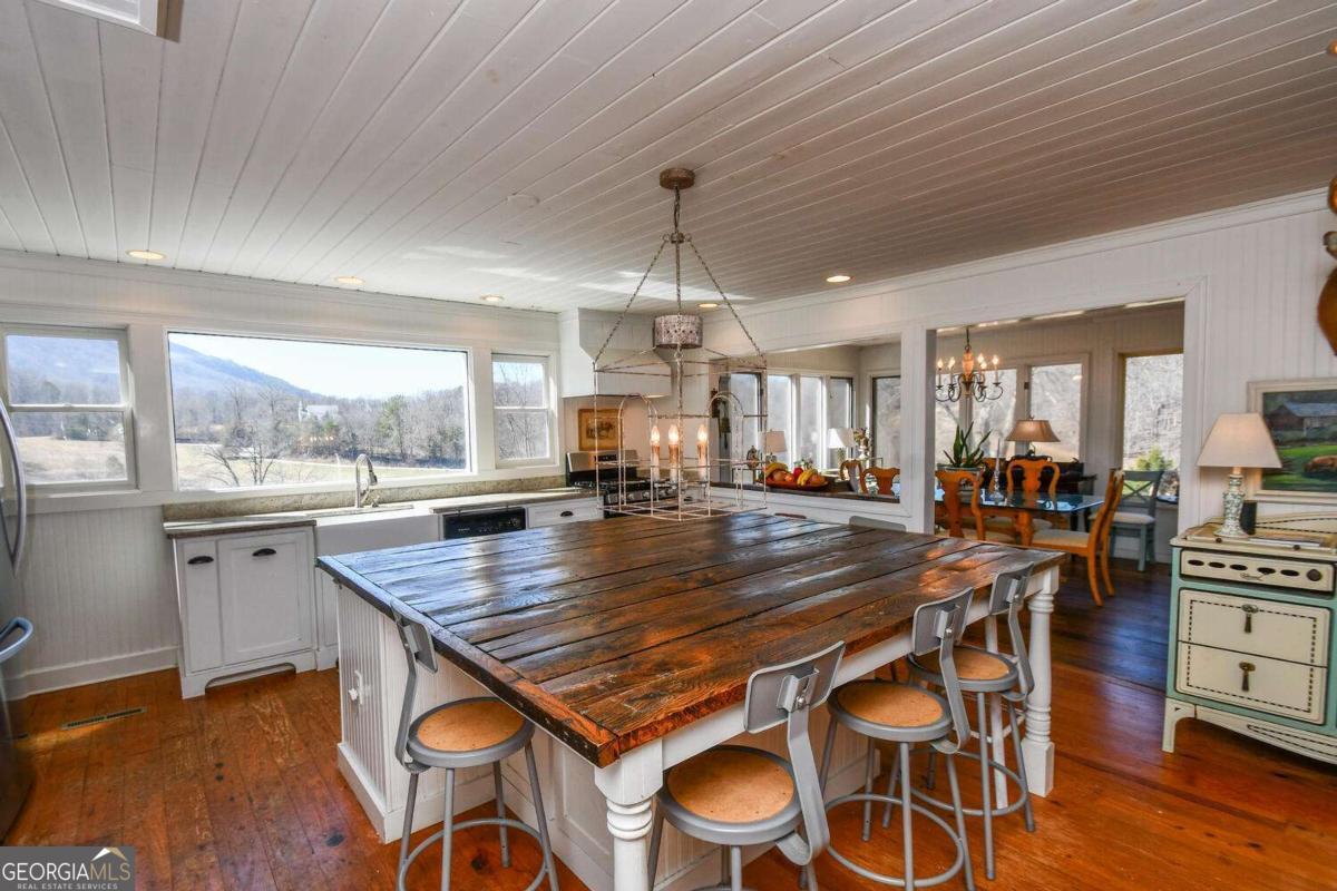 708 Hub Tatum Road Sautee Nacoochee, GA 30571 - Photo 51 of 100 a room with lots of wooden furniture wooden floor and windows
