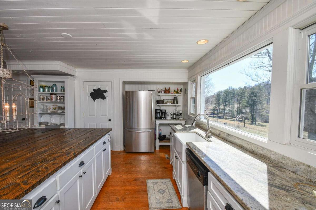 708 Hub Tatum Road Sautee Nacoochee, GA 30571 - Photo 55 of 100 a kitchen with stainless steel appliances granite countertop a sink stove and refrigerator