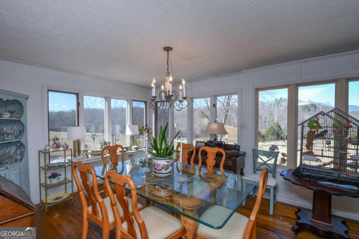 708 Hub Tatum Road Sautee Nacoochee, GA 30571 - Photo 61 of 100 a view of a dining room with furniture large windows and wooden floor