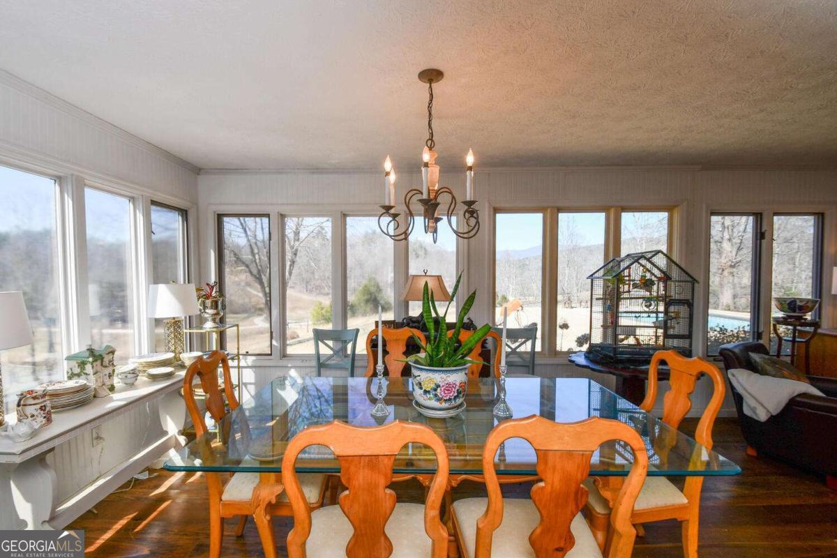 708 Hub Tatum Road Sautee Nacoochee, GA 30571 - Photo 63 of 100 a view of a dining room with furniture large windows and wooden floor