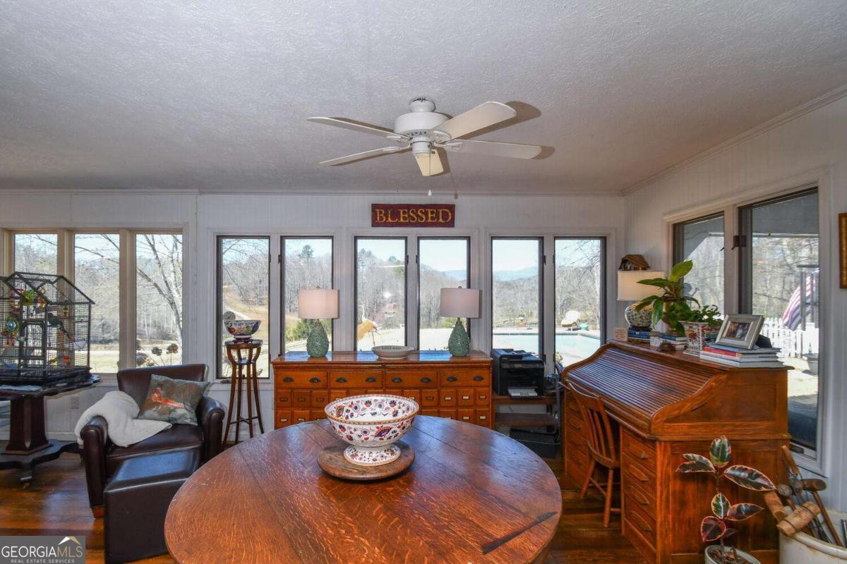 708 Hub Tatum Road Sautee Nacoochee, GA 30571 - Photo 66 of 100 a view of a dining room with furniture large windows and wooden floor