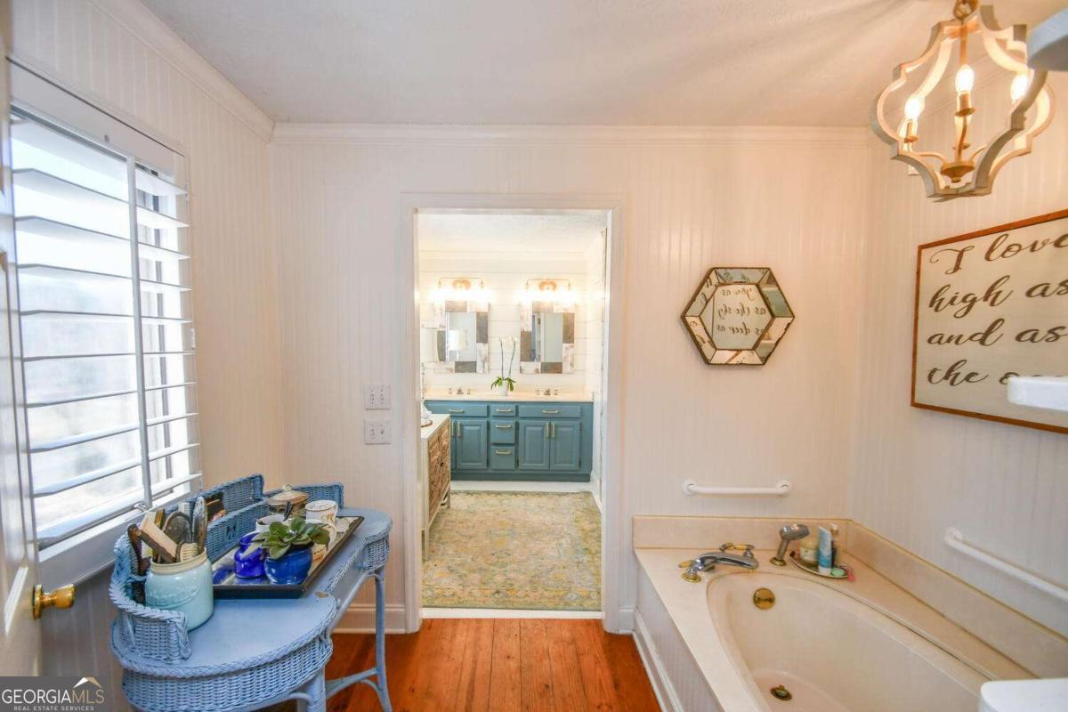 708 Hub Tatum Road Sautee Nacoochee, GA 30571 - Photo 76 of 100 a bathroom with a tub sink and mirror