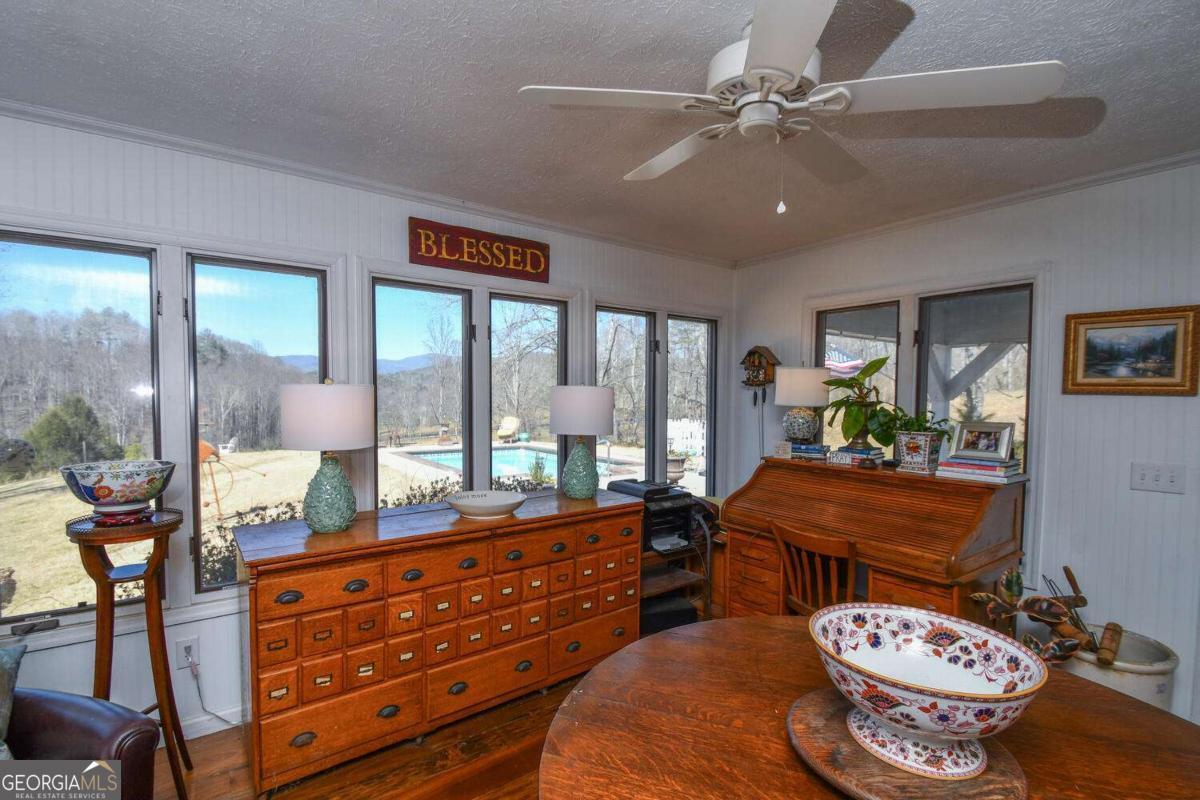 708 Hub Tatum Road Sautee Nacoochee, GA 30571 - Photo 78 of 100 a living room with furniture and a floor to ceiling window