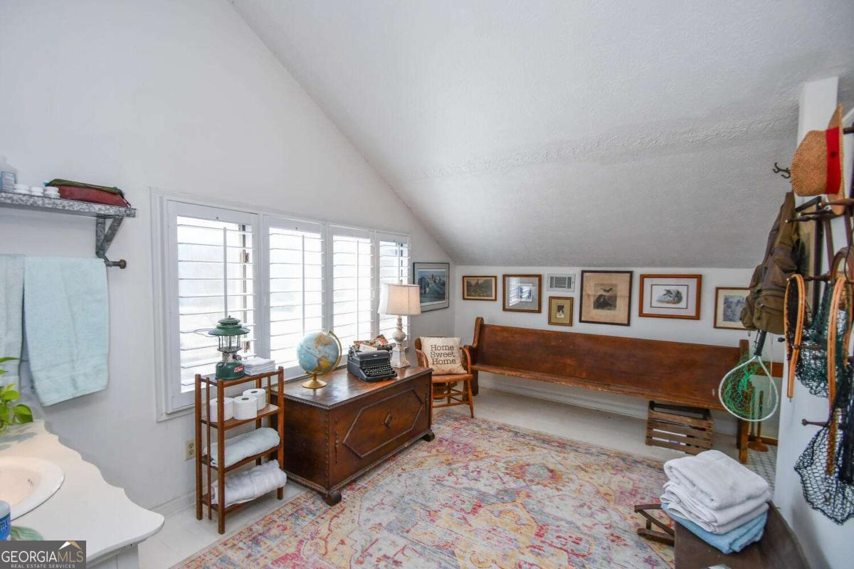 708 Hub Tatum Road Sautee Nacoochee, GA 30571 - Photo 84 of 100 a living room with furniture a rug and a floor to ceiling window