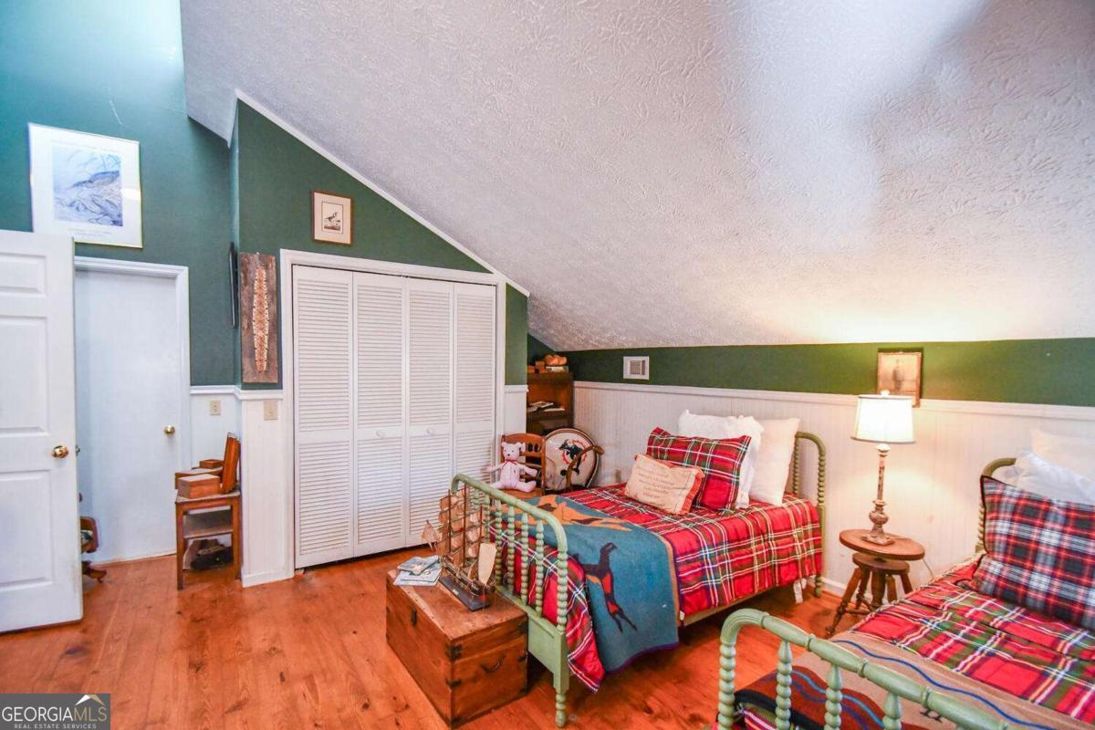 708 Hub Tatum Road Sautee Nacoochee, GA 30571 - Photo 87 of 100 a bedroom with a bed and wooden floor