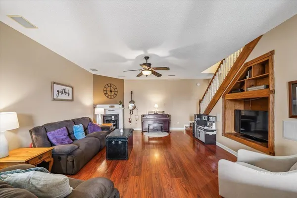 a living room with furniture and a fireplace