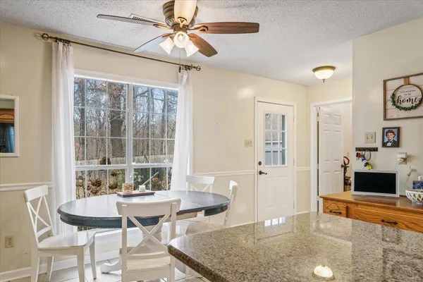 a dining room with furniture and window