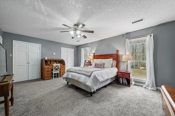 a bedroom with a bed and a chandelier