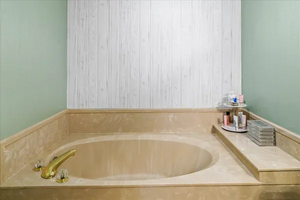 a bathroom with a granite countertop sink vanity mirror and toilet