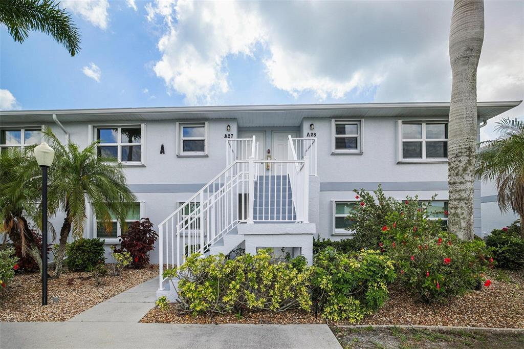 26485 Rampart Boulevard, Unit A27 Punta Gorda, FL 33983 - Photo 7 of 27 a front view of a house with a garden