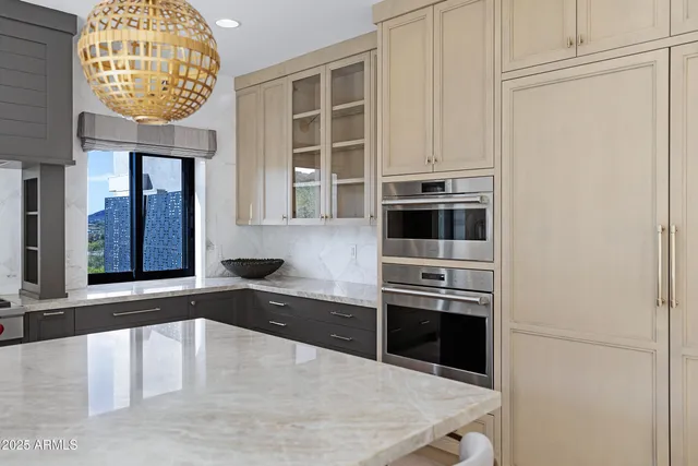 a bedroom with a bed and a flat tv screen on the dresser