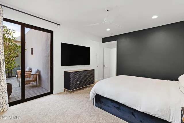 a bathroom with a tub a sink and a large window