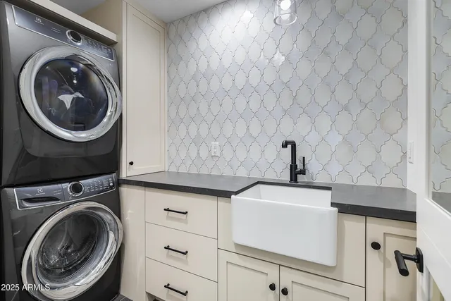 a view of a backyard with couches plants and large trees
