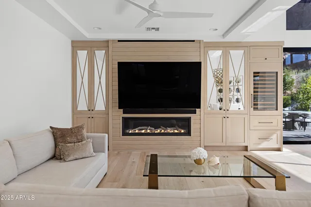 a living room with furniture a flat screen tv and a fireplace