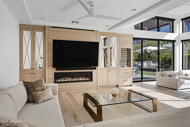 a living room with furniture a flat screen tv and a fireplace