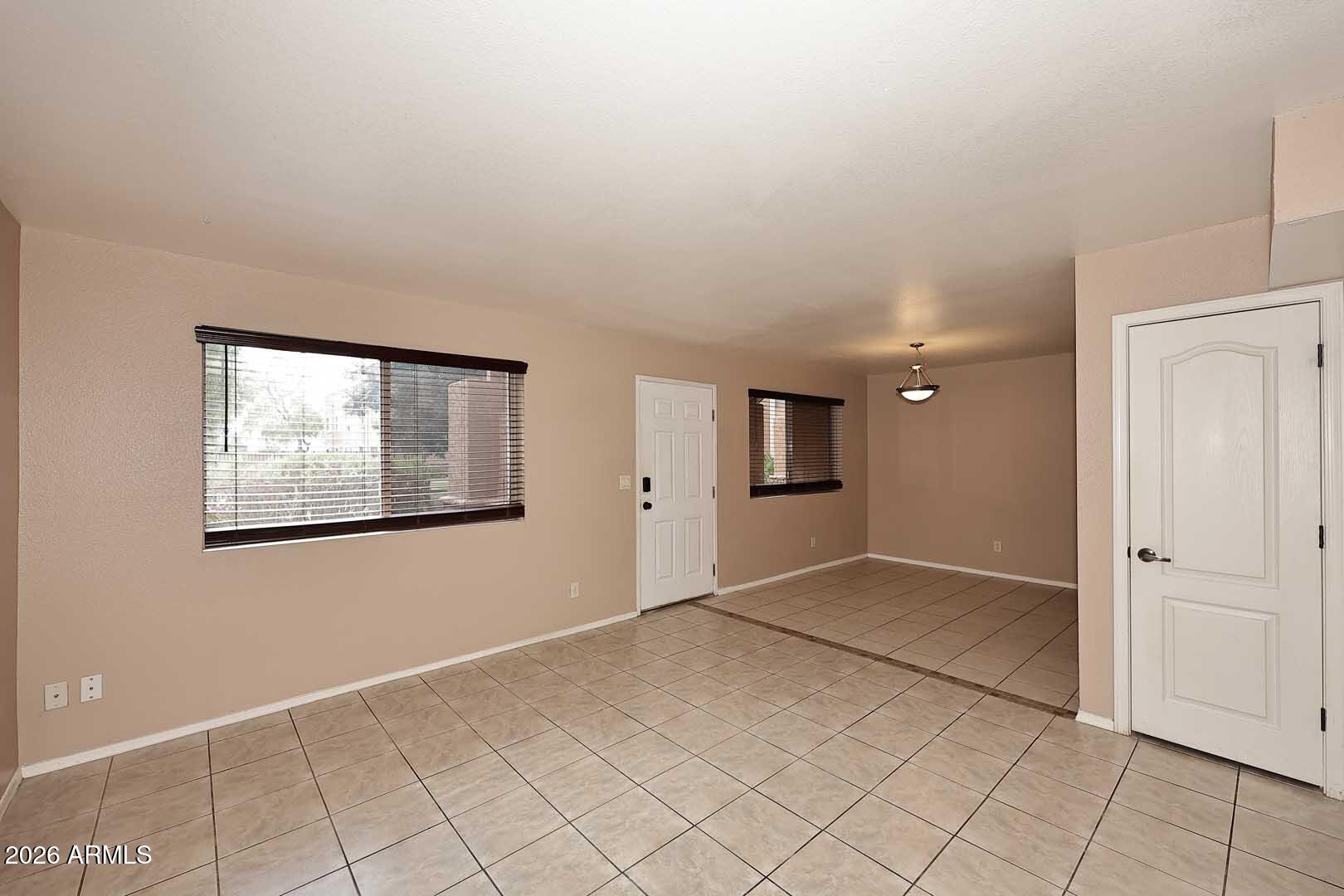 303 North Miller Road, Unit 1007 Scottsdale, AZ 85257 - Photo 9 of 45 an empty room with windows