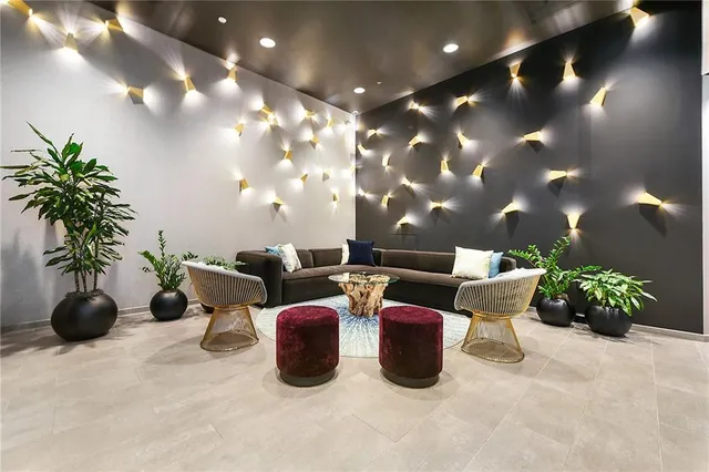 a lobby with furniture and potted plants