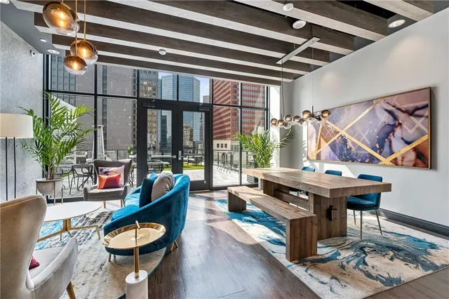 a living room with furniture and a floor to ceiling window