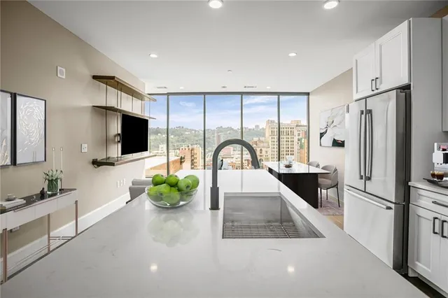 a kitchen with stainless steel appliances a microwave a sink a stove and a refrigerator