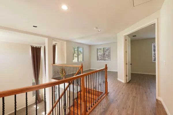 a view of a room with wooden floor and windows