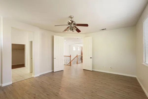 a spacious bathroom with a shower a sink and a mirror