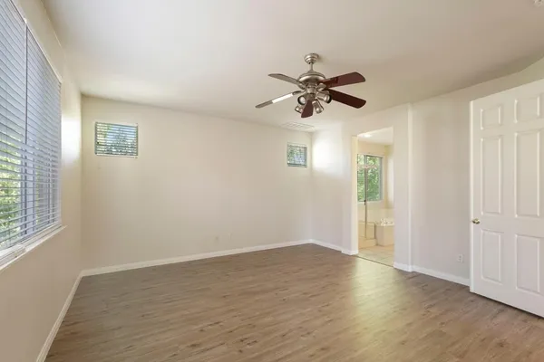 a view of a room with wooden floor and white walls